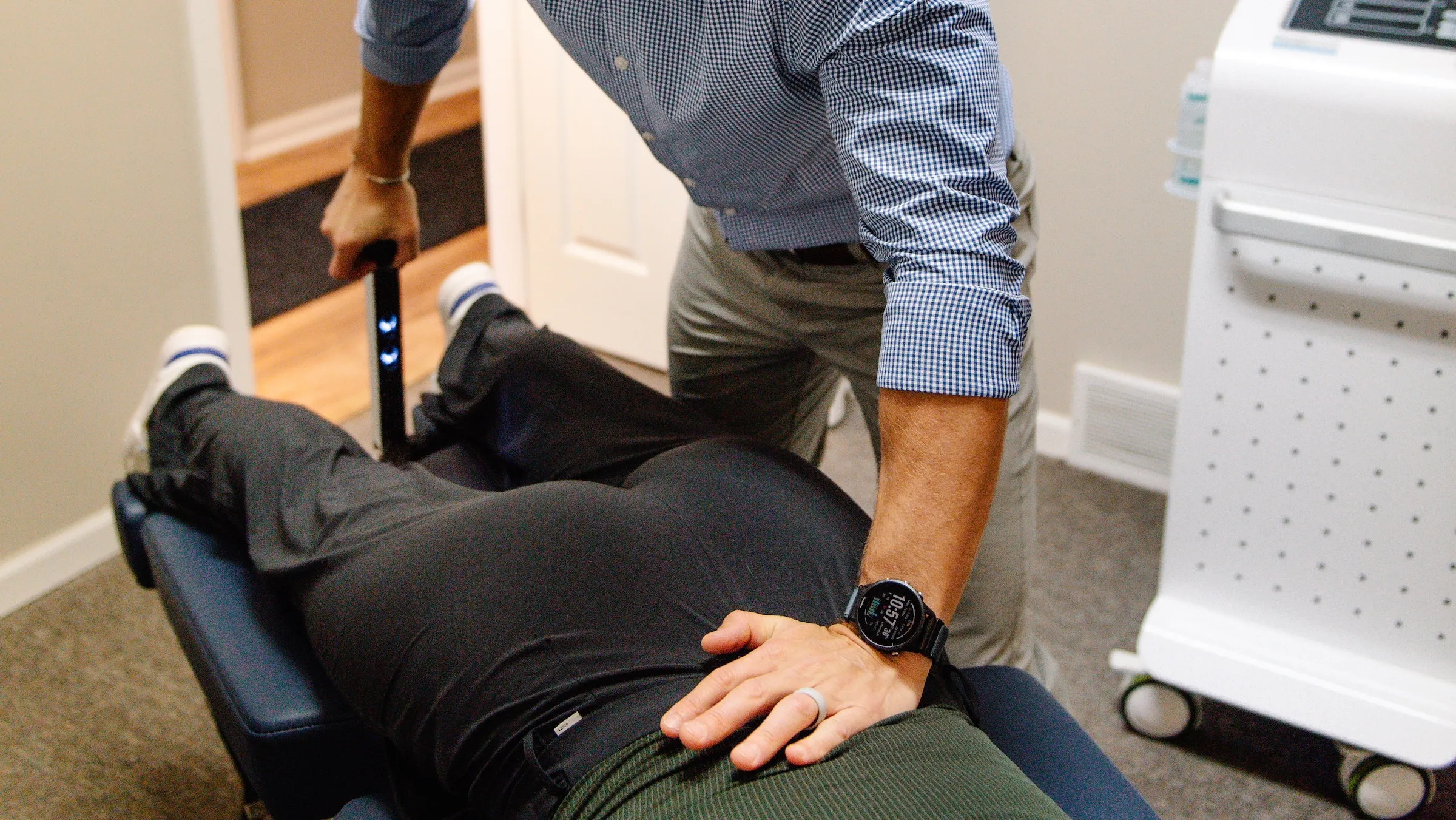 A REACH clinician treating a patient's lower back on a decompression table in Plymouth, MI