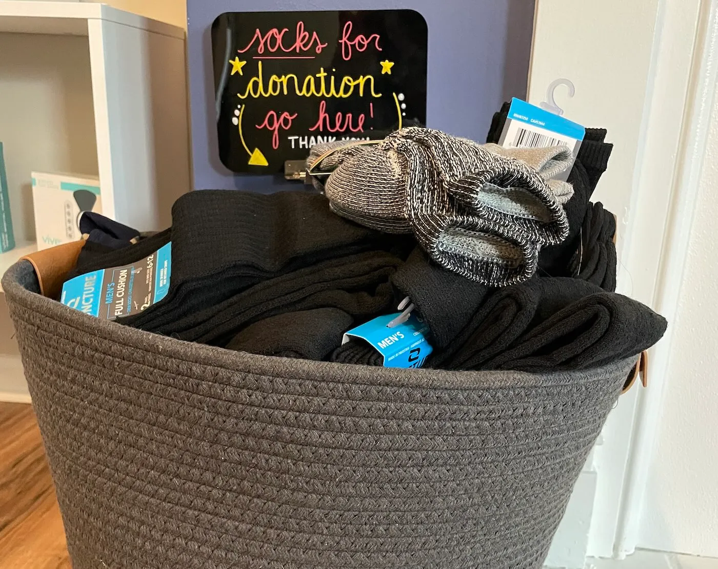A basket overflowing with new socks donated through Community OutREACH's homeless sock drive