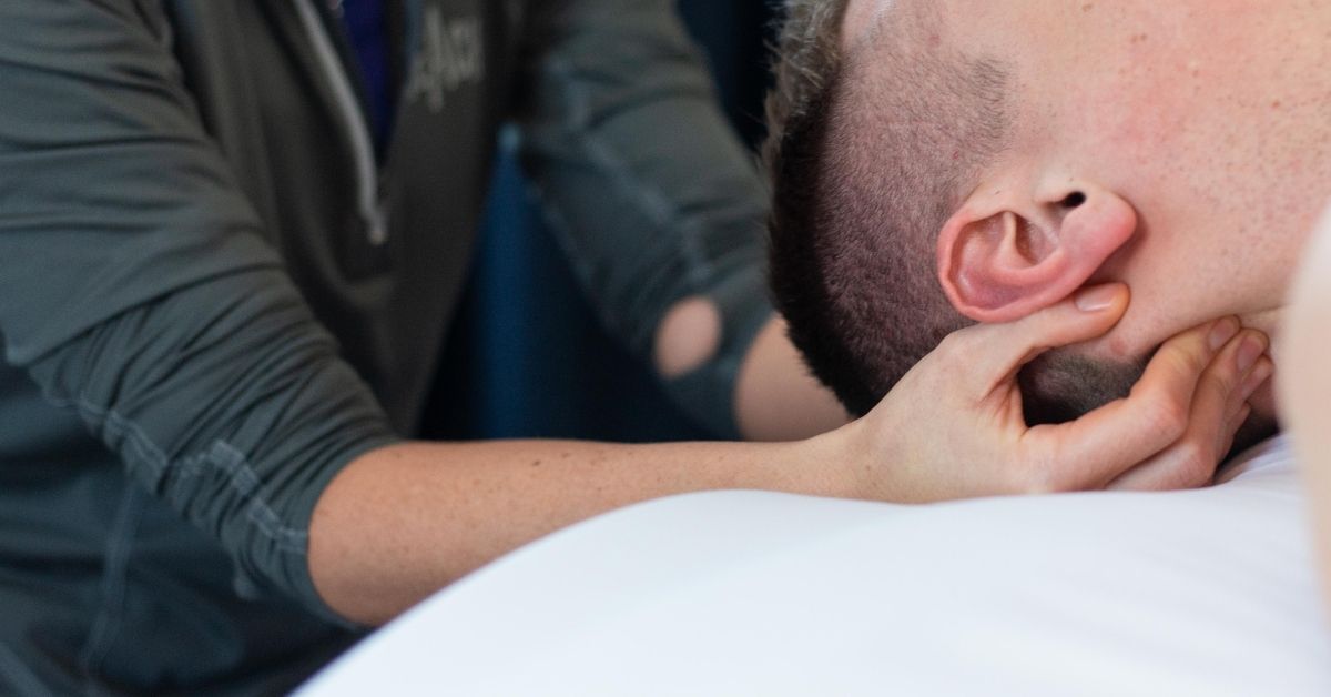 Massage Therapist Massaging A Man's Neck | Massage Near Northville, MI