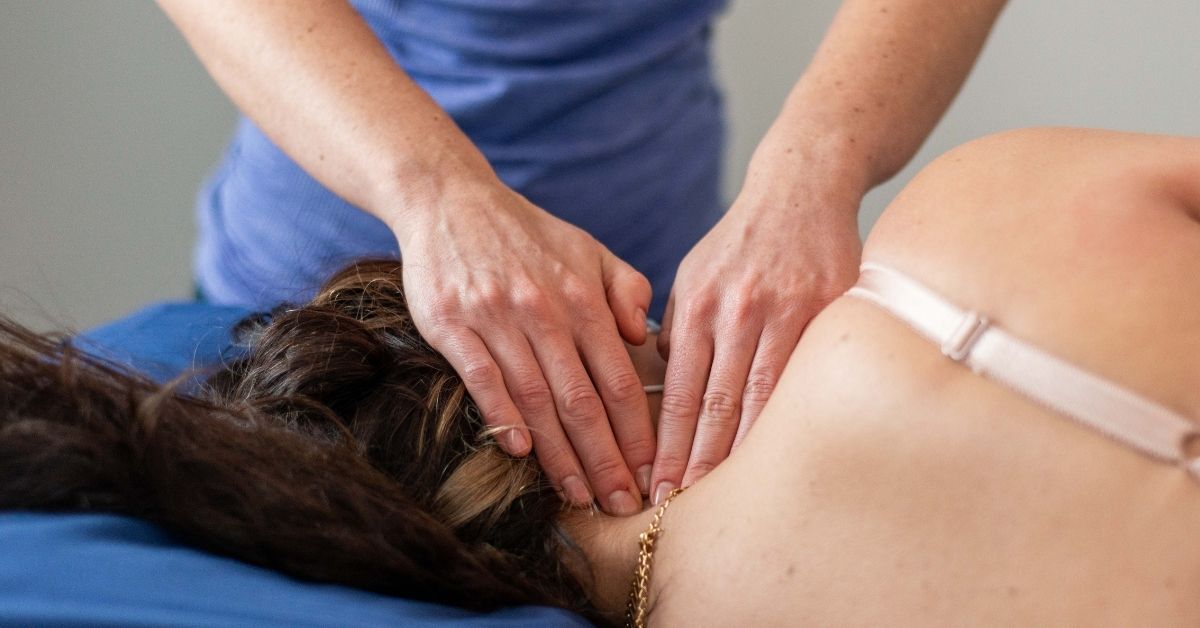 Massage Therapist Massaging A Woman's Neck