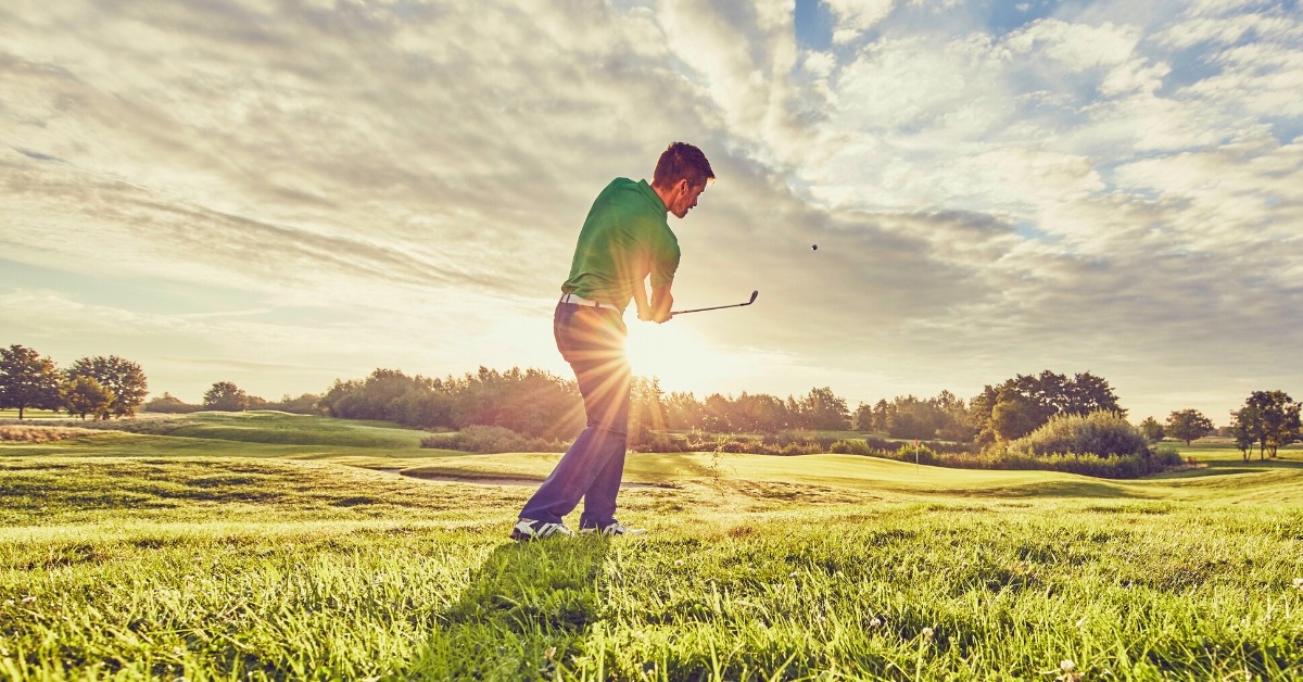 Golfer Swinging Club With Sunrise Background | Pain Relief In Michigan | REACH Rehab + Chiropractic