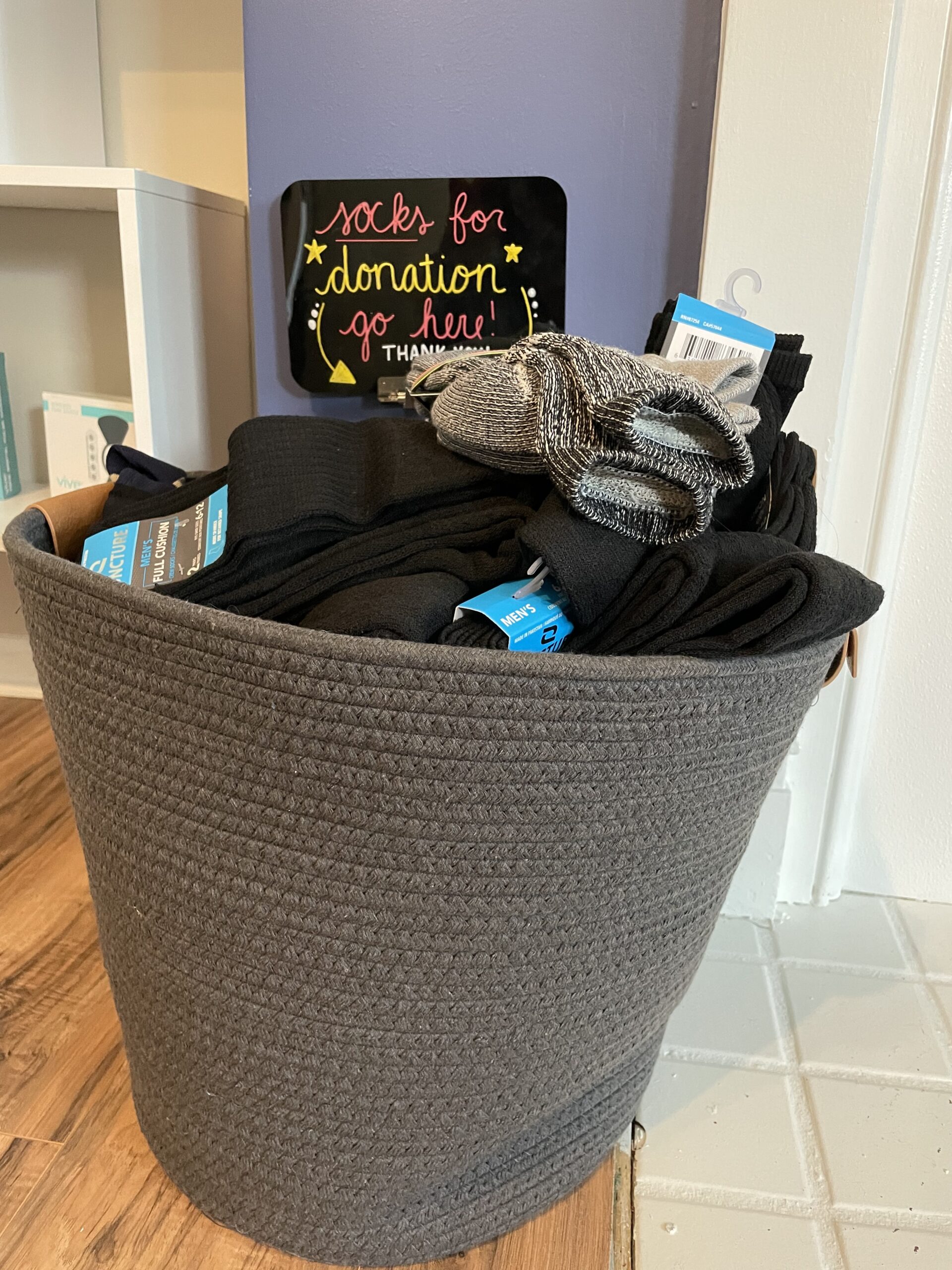 Basket With Socks Collected For The Homeless | Community OutREACH | REACH Rehab + Chiropractic
