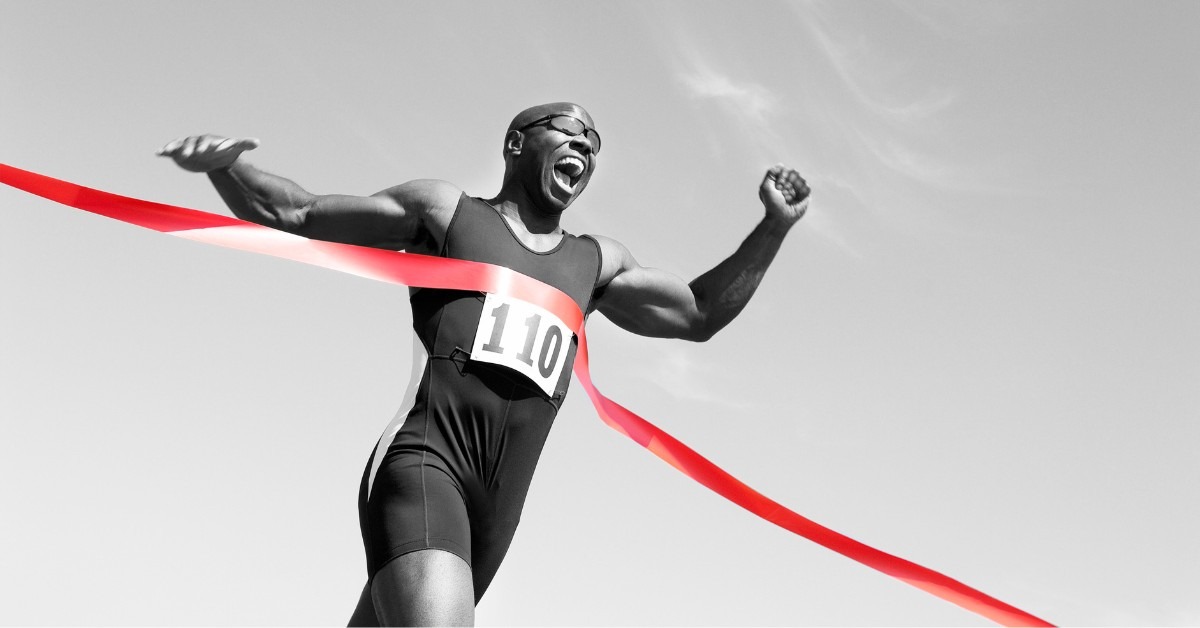 A Runner Crossing A Finish Line | Advanced Sports Assessments | REACH Rehab +Chiropractic