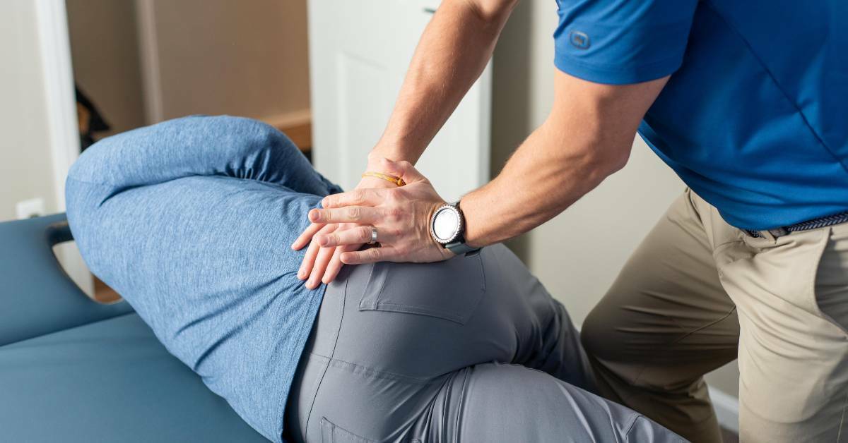 Patient Laying on a Chiropractic Table Getting Help with Sciatica Pain | REACH Rehab + Chiropractic