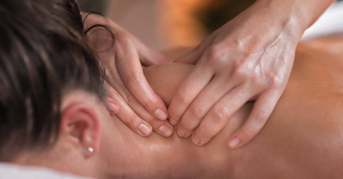 Woman getting their neck massaged. massage therapy. REACH Rehab + Chiropractic.